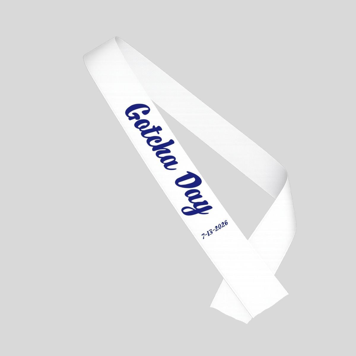 White sash with blue "Gotcha Day" and date sash for adoption on a gray background.