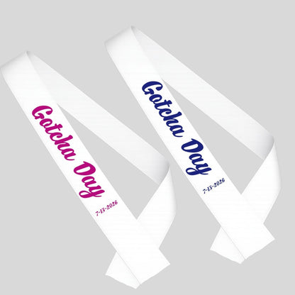 Two white sashes with 'Gotcha Day' text in blue or pink on a gray background.