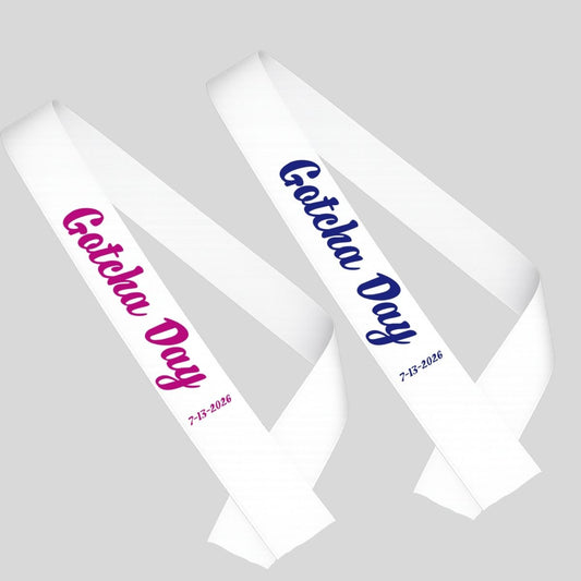 Two white sashes with 'Gotcha Day' text in blue or pink on a gray background - Little Gift Nook