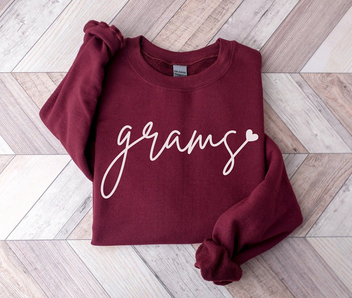 Grams maroon crewneck sweatshirt folded with white grams and heart on front. Little Gift Nook