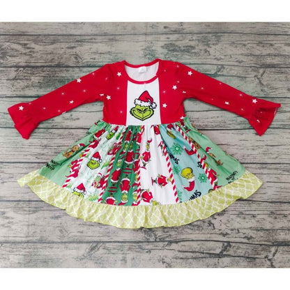 Girl's red and green Grinch theme twirl dress laying on wood background. 