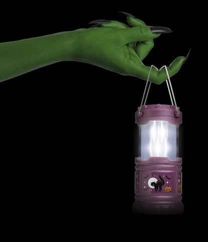 Halloween Pop-Up Lantern being held by witch hand. 