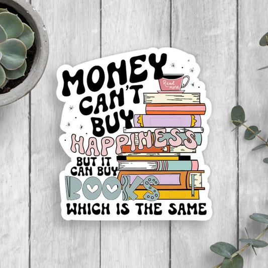 Money can't buy Happiness but it can buy books colorful waterproof books sticker on white background. Sticker is stilling on gray wood background. Little Gift Nook.