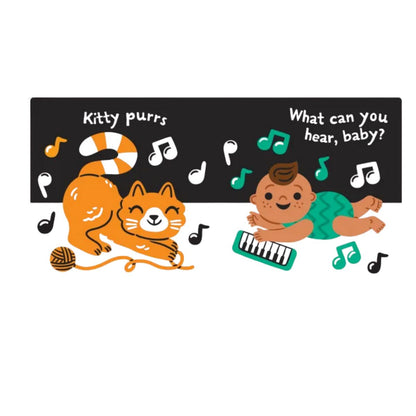 Indestructibles baby book "Hear the Sounds" inside pages with baby playing keyboard and cat and music notes on a black and white background.