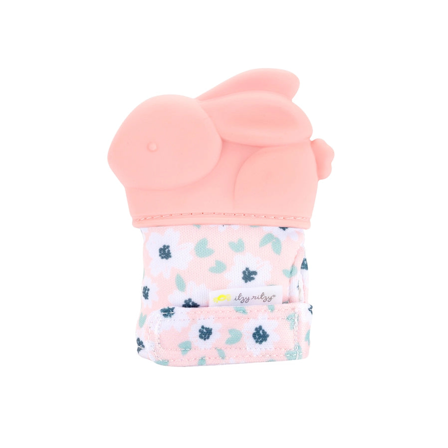 Itzy ritzy baby pink bunny shaped teething mitt sitting on white background.