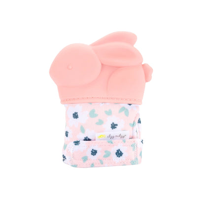 Itzy ritzy baby pink bunny shaped teething mitt sitting on white background.