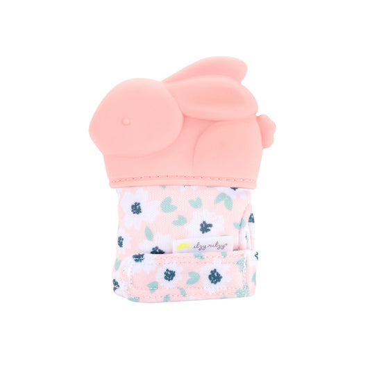 Itzy ritzy baby pink bunny shaped teething mitt sitting on white background.