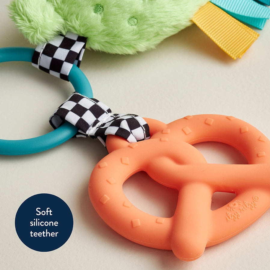 Close up of itzy Pal Parker the Pickle Teether Toy pink silicone pretzel teether - Little Gift Nook