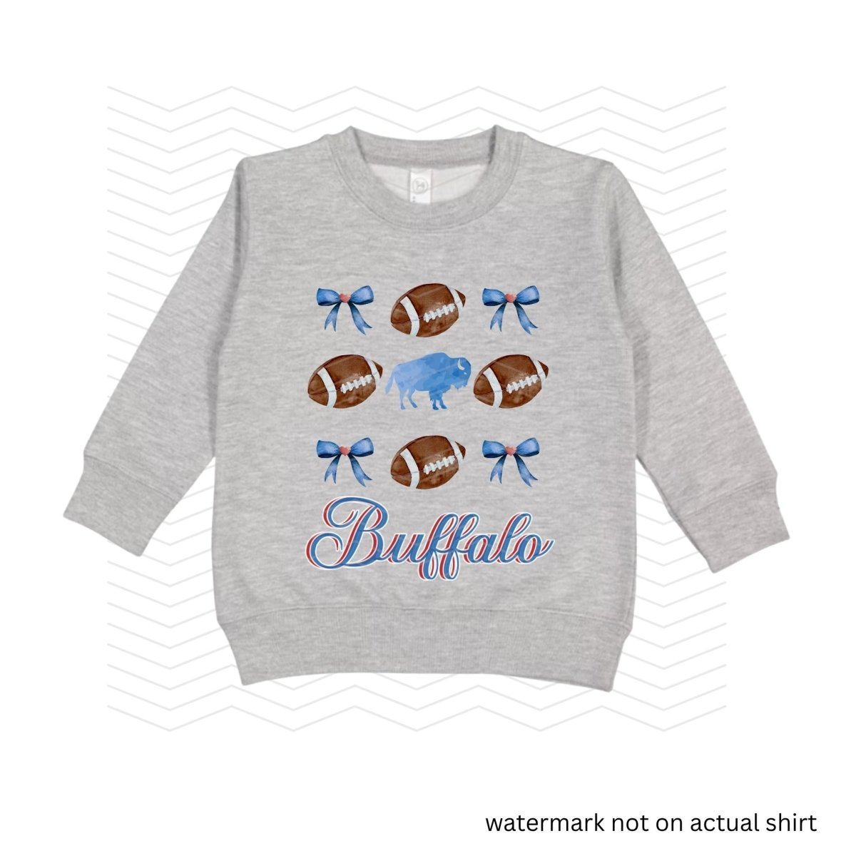 heather gray sweatshirt with blue bows, buffalo, and brown footballs with the text 'Buffalo" in blue and red cursive below image on front.