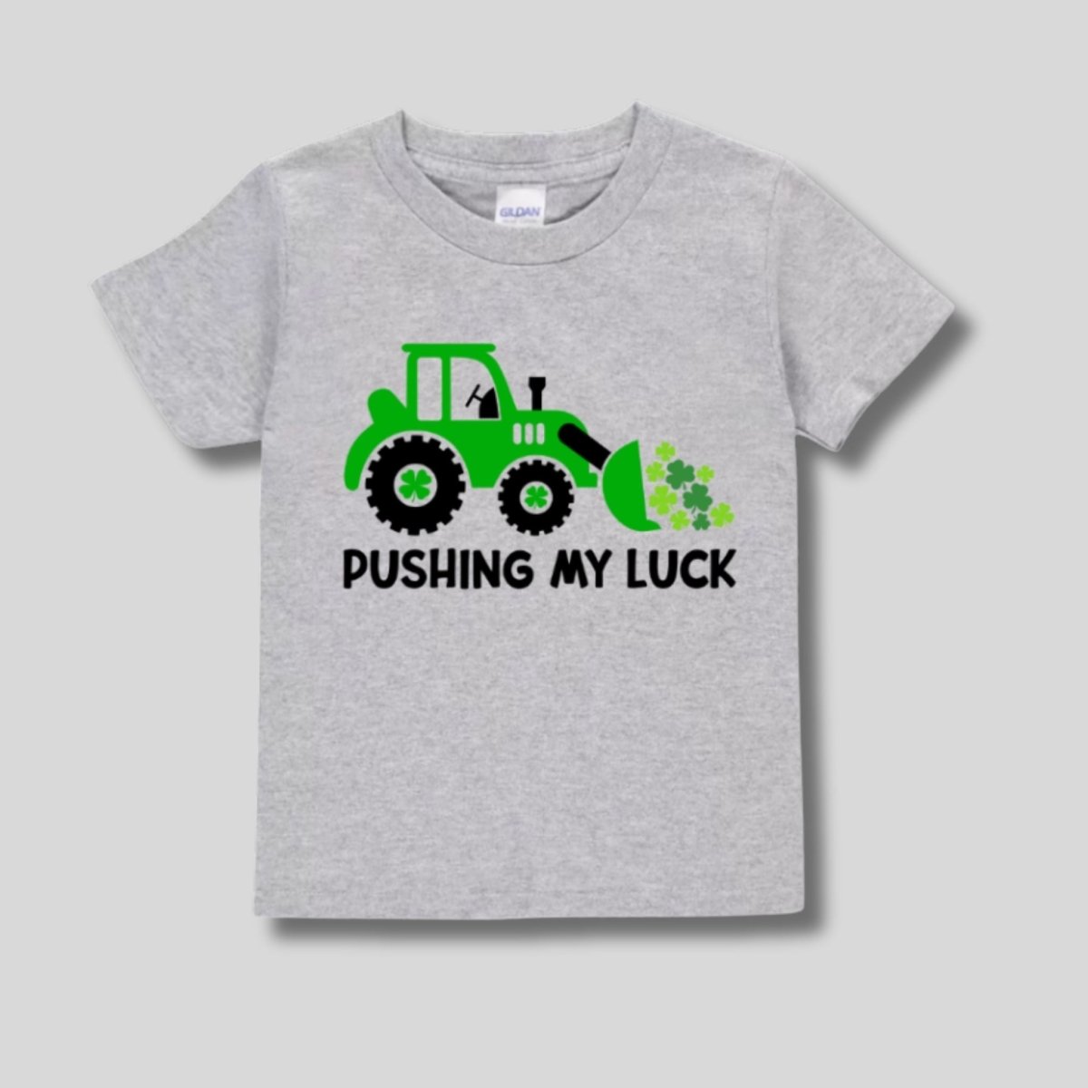 heather gray toddler tshirt with green tractor and clovers "pushing my luck" on front. On gray background. 