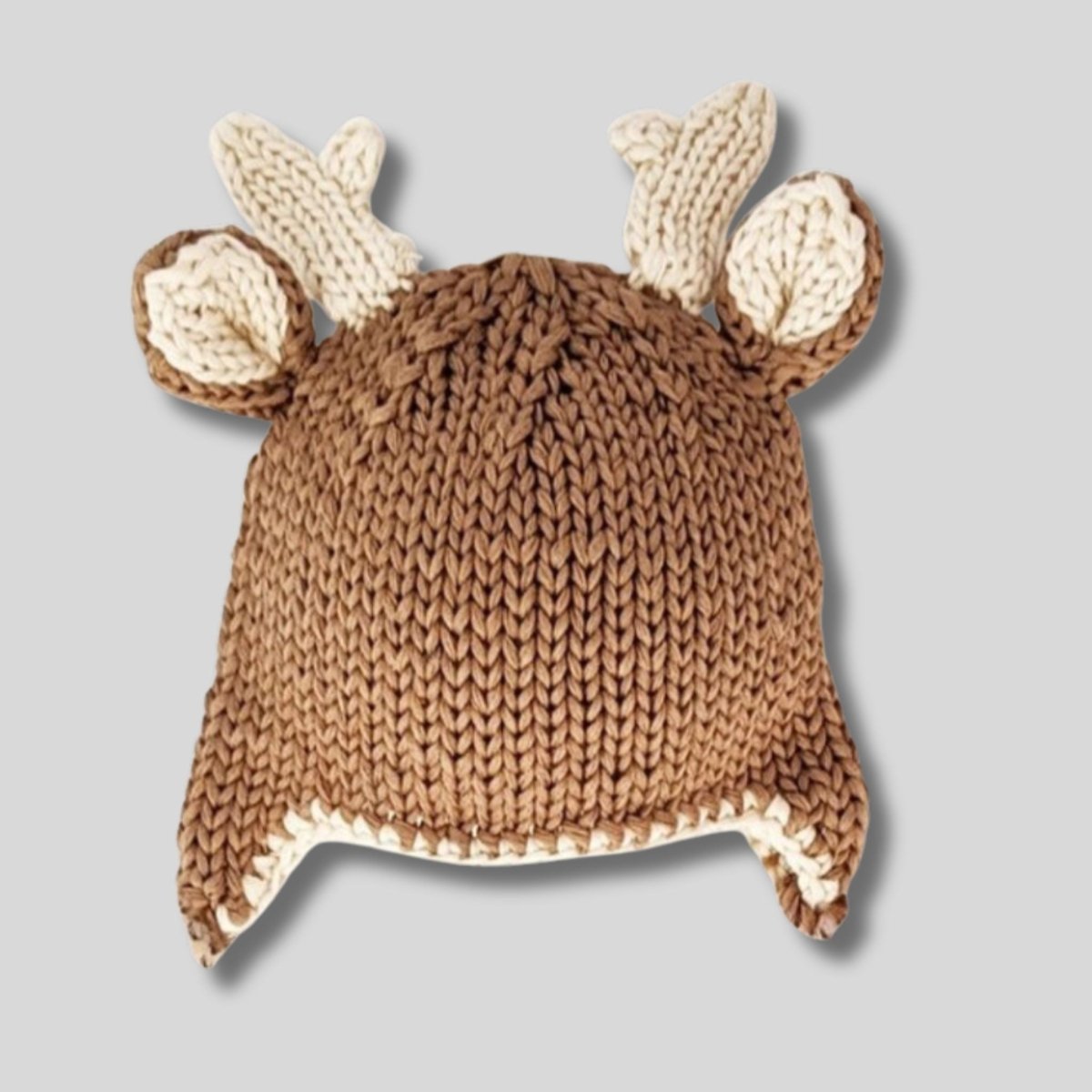 Buck Deer Beanie Knit Baby Hat. Soft yarn and trimmed with adorable antlers and little ear flaps. Cute baby gift. Shown on gray background.  Little Gift Nook.
