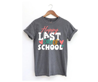 Gray tshirt with pink, white, and green Last Day of School on front on a hanger on a white background. Little Gift Nook