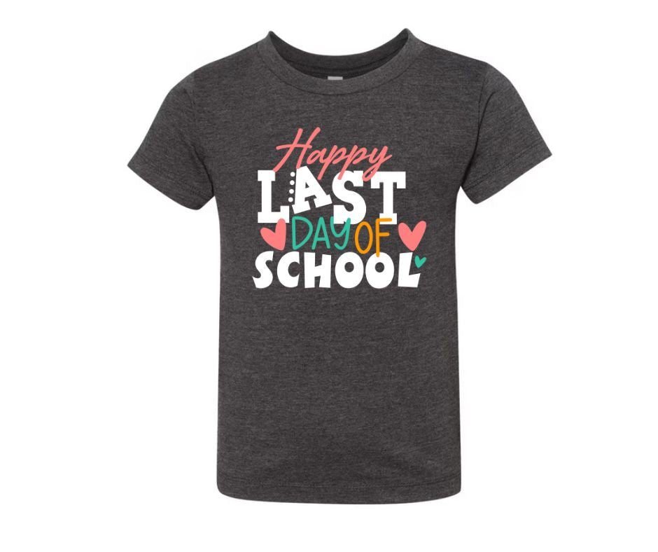Dark gray tshirt with pink, white, and green Last Day of School on front on a white background. Little Gift Nook