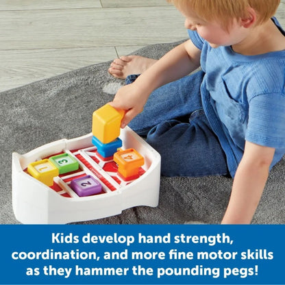 Child playing with Learning Resources Barnyard Pounding Bench toy with yellow hammer on a gray carpet. 