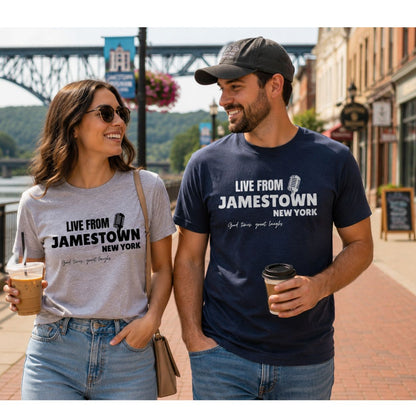 Woman and Man wearing "LIVE FROM JAMESTOWN NEW YORK" t-shirts in heather gray and navy walking with coffee on small town street. 