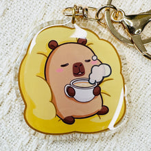 Load image into Gallery viewer, Capybara lounging with coffee acrylic keychain. Double sided. Little Gift Nook.