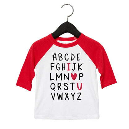 I love you Heart Alphabet Shirt. White raglan red sleeve tshirt with alphabet written in black letters with I heart and u in red. Kids tshirt. Little Gift Nook.