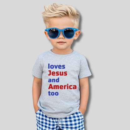 little toddler boy wearing heather gray tshirt with red and blue "loves Jesus and America too" lettering on front shown on gray background - Little Gift Nook