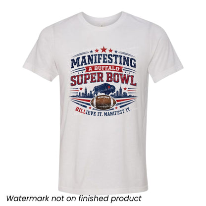 white tshirt with red and blue "Manifesting a Buffalo Super Bowl Billieve it manifest it" design on front laying on a white background.