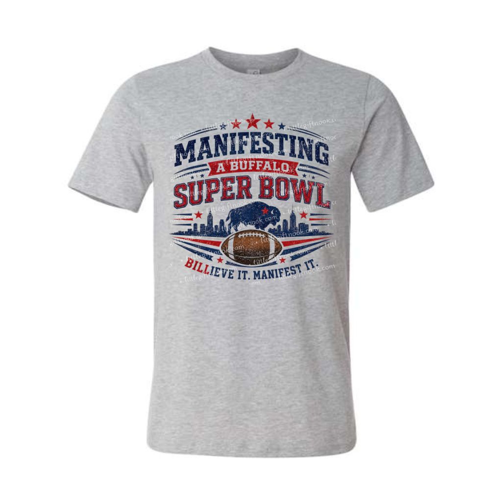 Gray tshirt with red and blue "Manifesting a Buffalo Super Bowl Billieve it manifest it" design on front on a white background.