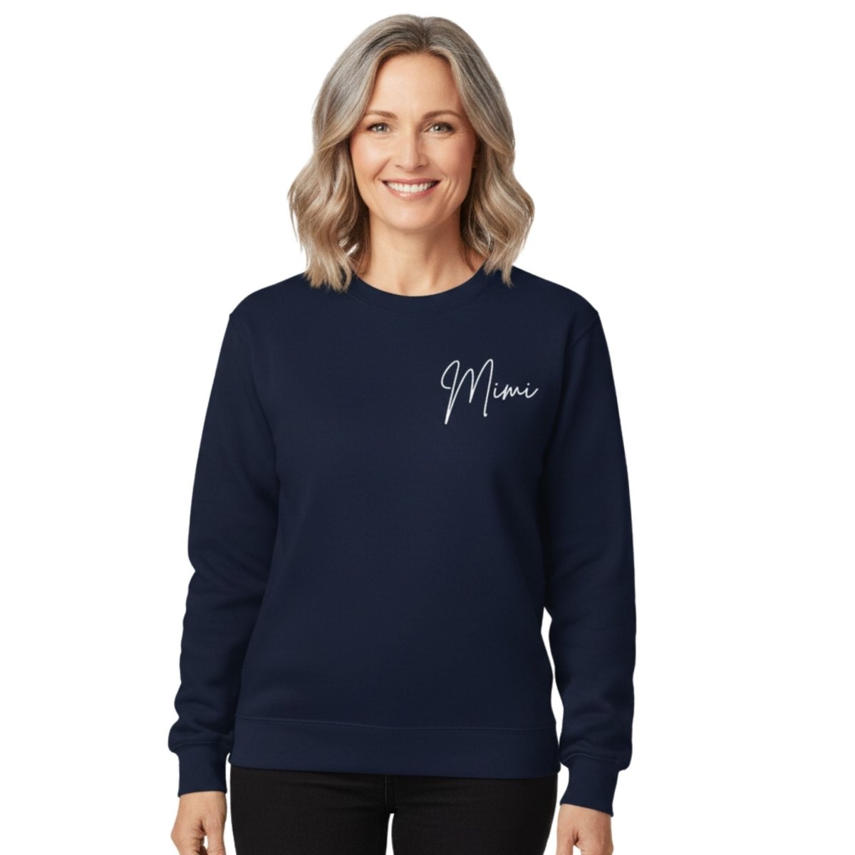 Woman wearing a navy blue sweatshirt with 'Mimi' on it against a white background