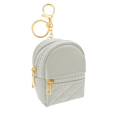 Load image into Gallery viewer, Light Gray Quilted mini backpack keychain. Has 2 pockets that open with gold zippers and gold keyring, chain, and lobster clip. Measures 3.94 inches tall. Little Gift Nook.