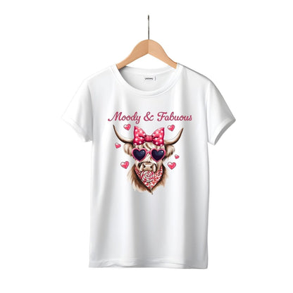 white tshirt with pink highland cow in pink heart sunglasses, hair bow, bandana, and sucker moody and fabulous on front. Little Gift Nook