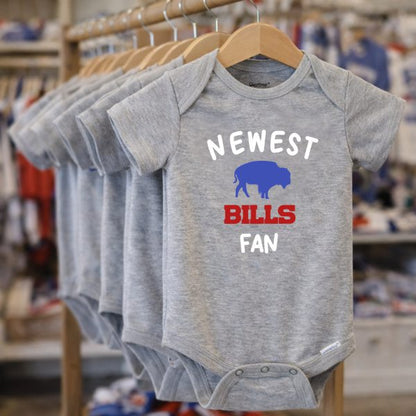Rack with gray "newest bills fan" onesies hanging in a row. 