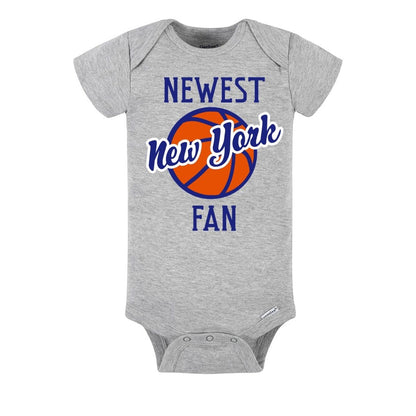 Gray baby onesie with 'Newest New York Fan' text and basketball graphic on a white background.