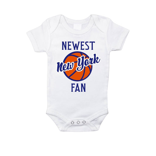 White baby onesie with 'Newest New York Fan' text and basketball graphic on a white background - Little Gift Nook