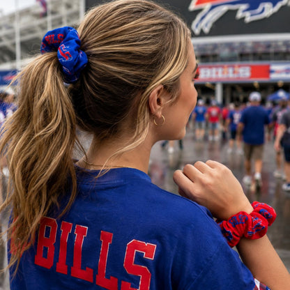 Woman at Buffalo Bills game wearing blue Bills logo scrunchie in a ponytail and a red Bills logo scrunchie on her wrist.  