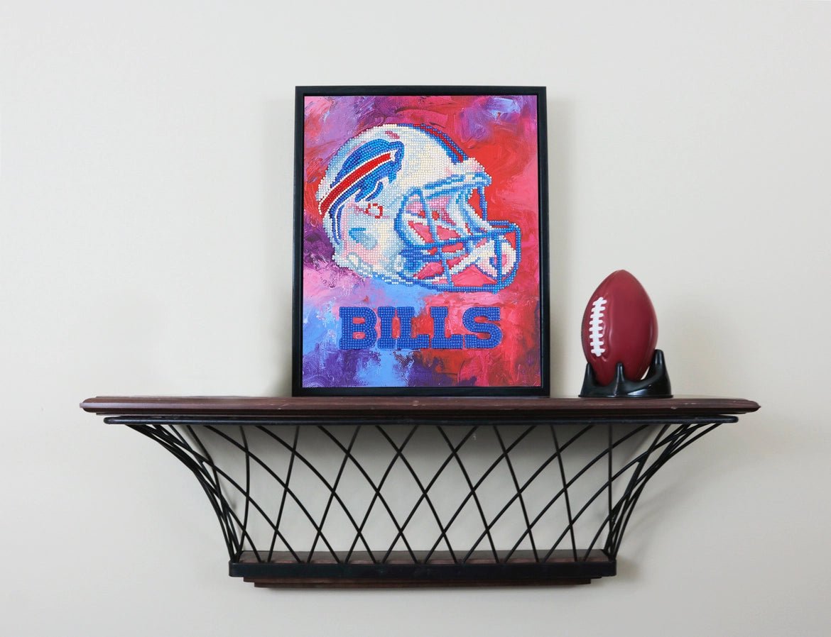NFL officially licensed Buffalo bills logo helmet diamond art craft kit complete displayed on shelf on gray wall with football.