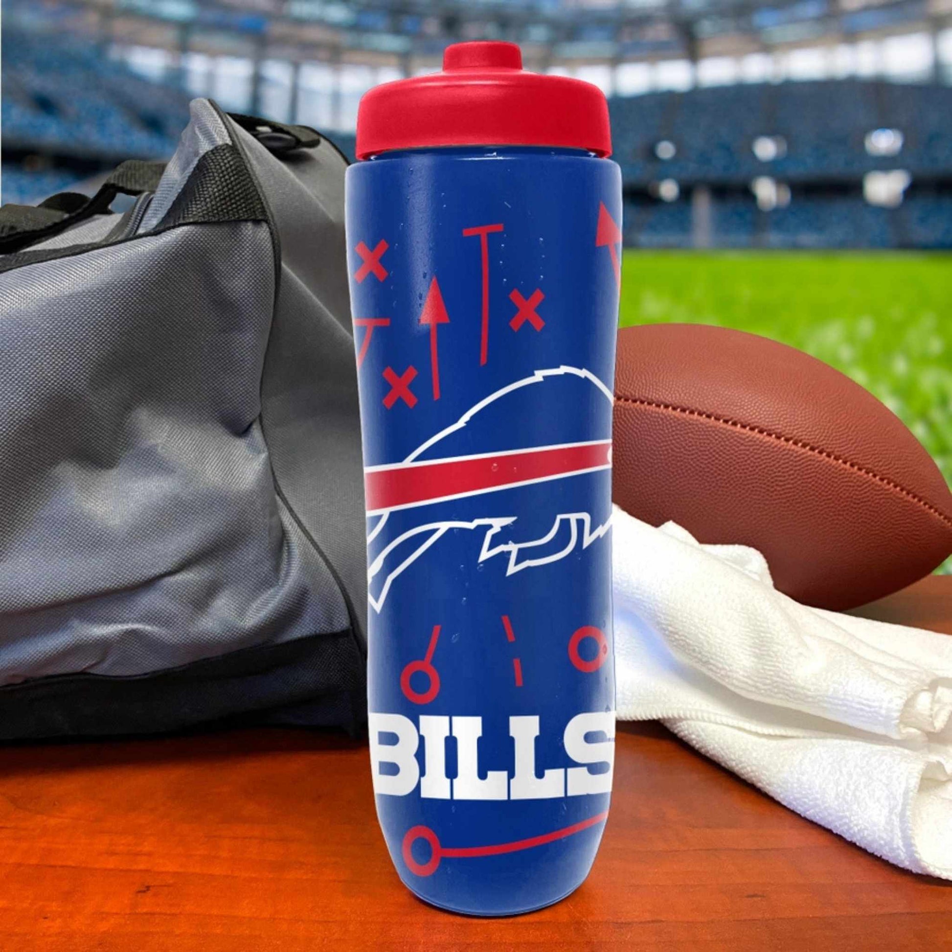 Buffalo Bills logo blue and red squeezy plastic water bottle standing on football field background.