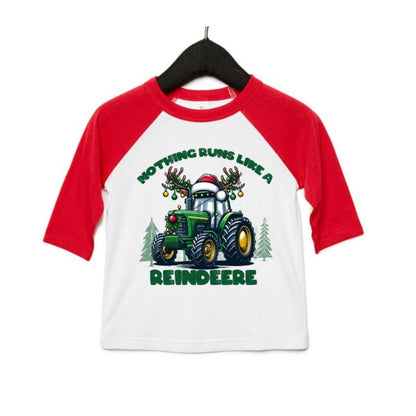 Toddler red sleeve white baseball style tshirt with green reindeer tractor and "Nothing runs like a Reindeer" on front sitting on white background. Little Gift Nook