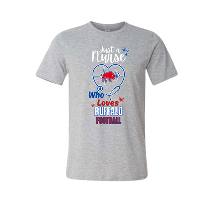 A heather gray short-sleeve crewneck t-shirt featuring a graphic design on the front. The design includes a blue stethoscope forming a heart shape around a red buffalo silhouette, with the text 'Just a Nurse Who Loves BUFFALO FOOTBALL' in white, blue, and red lettering.