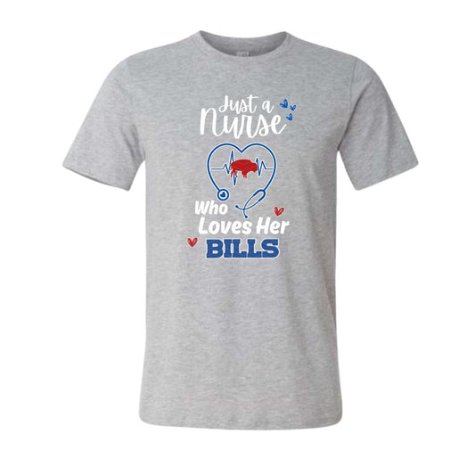 heather gray tshirt with white red and blue text "Just a nurse who loves her BILLS" and stethoscope with red buffalo in center of heartbeat. Shirt is laying on white background. 