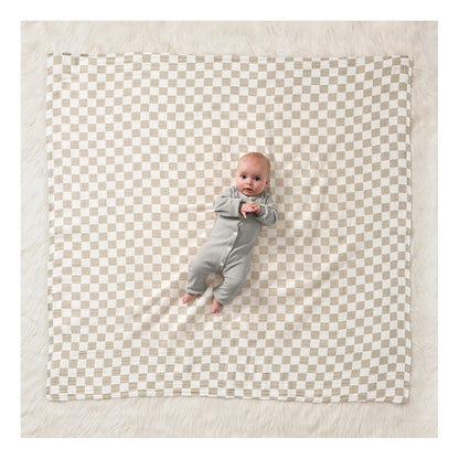 Nursing Cover & Swaddle Blanket in Tan & white checkered pattern. Blanket laid out with baby laying on it. - Little Gift Nook