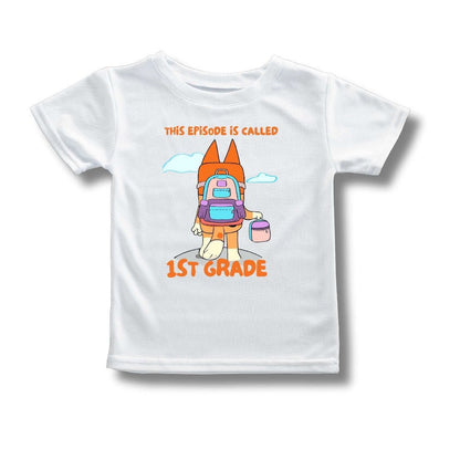 Kids white tshirt with orange dog carrying a backpack and lunchbox and text "This episode is called 1st Grade" on front laying on white background.