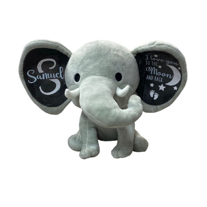 Gray Elephant Plush with Personalized ears with baby name and message sitting on white background. Little Gift Nook.