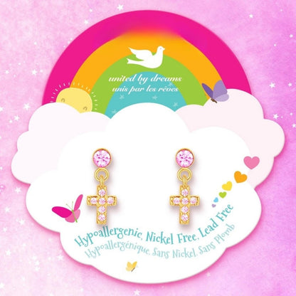 Pink gold cubic zirconia cross dangle pierced earrings sitting on rainbow cloud package card. 