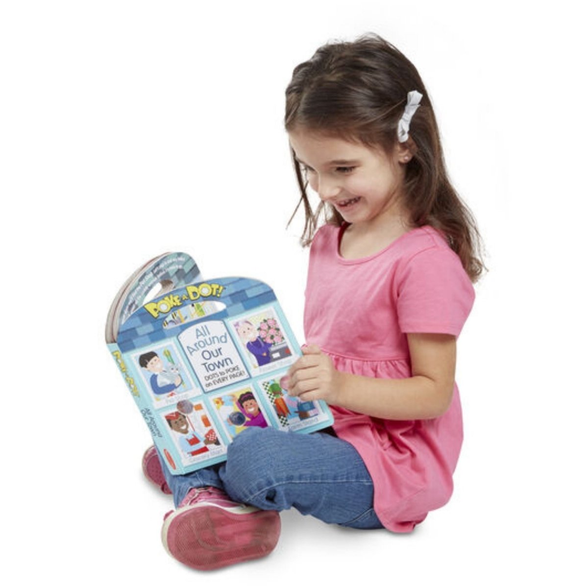 Little Girl sitting reading Poke a Dot All Around Town Board Book on a white background. 