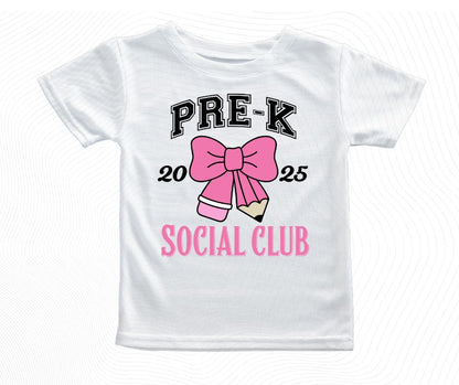 White t-shirt with 'Pre-K Social Club' design featuring a pink bow and pencil on a white background.