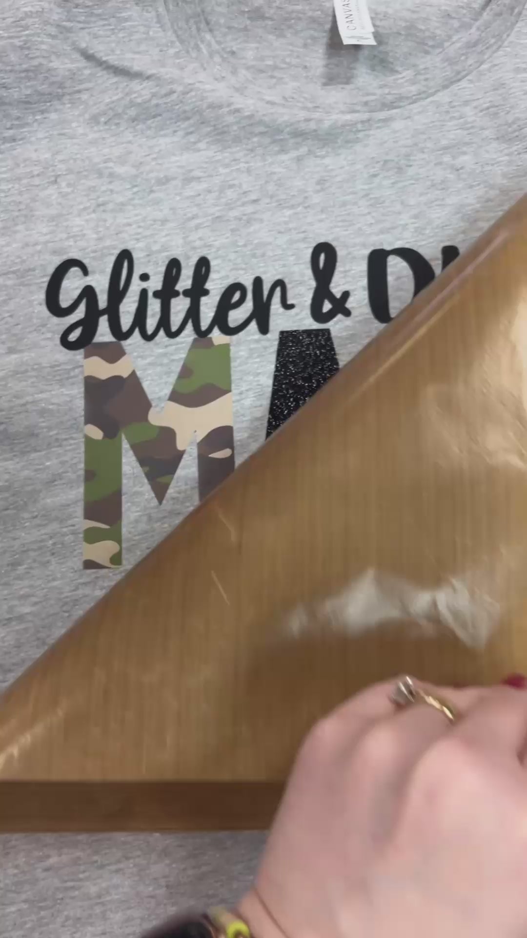 Video of custom t-shirt pressed with Glitter and Dirt Mama of both with black and camo lettering at the Little Gift Nook in Jamestown, NY.