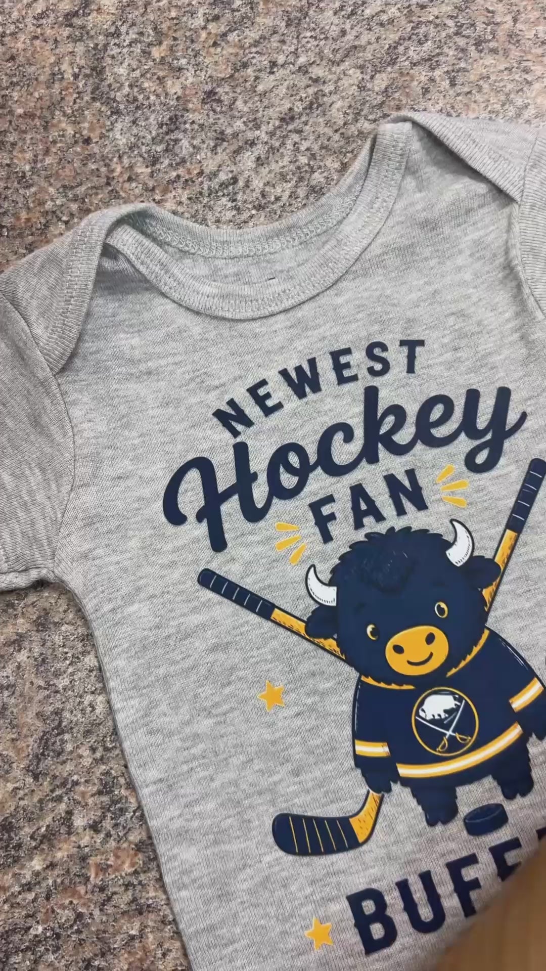 Video of custom baby onesie with "Newest Hockey Fan Buffalo" on front at the Little Gift Nook Jamestown, NY