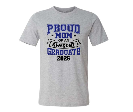 Gray tshirt with blue and black text "Proud MOM of an awesome graduate 2026" sitting on a white background. Little Gift Nook