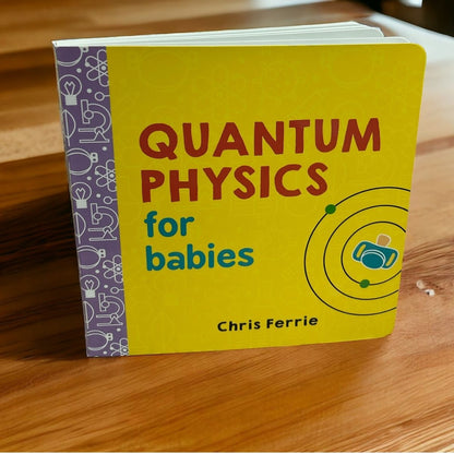 Book titled 'Quantum Physics for Babies' by Chris Ferrie standing on a wooden surface.