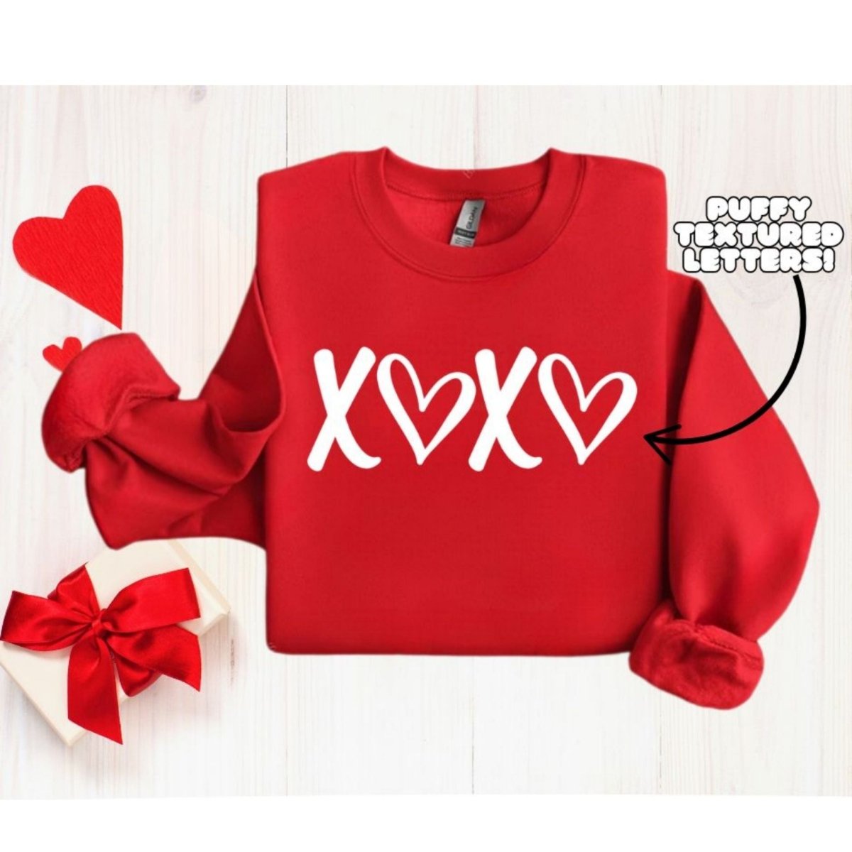 Red XOXO Puffy Letters Crewneck. Unisex fit fleece lined red crewneck sweatshirt with white textured puffy lettering xoxo on front. Makes cute gift. Little Gift Nook.