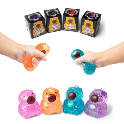 Scrunchems® Sugar Capybara Squishy Fidget Toy in multiple colors being squished and sitting in boxes on white background.