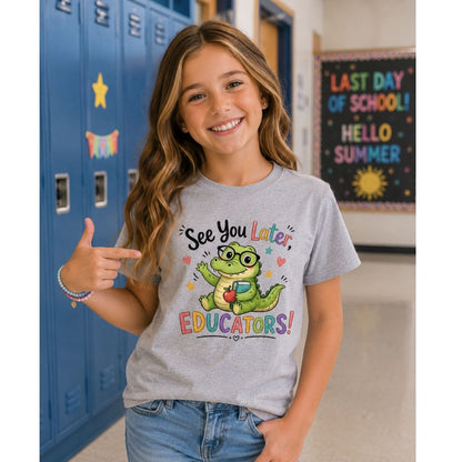 Young girl in a classroom wearing a t-shirt "See you later educators" with alligator on front for last day of school.