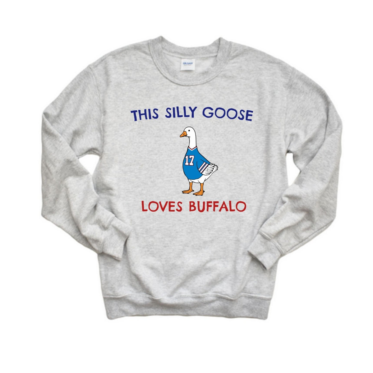 A light heather gray crewneck sweatshirt featuring a graphic of a cartoon goose wearing a blue jersey with the number 17, with the text 'THIS SILLY GOOSE' above and 'LOVES BUFFALO' below in blue and red lettering.